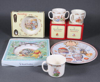 A Royal Doulton Bunnykins mug, two 2 handled ditto, a bowl and spoon, 2 wall plates and 2 mugs 