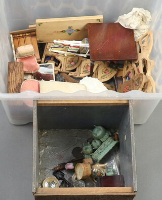 A collection of dolls house furniture and a miniature tea chest (wormed), all contained within a small plastic box 