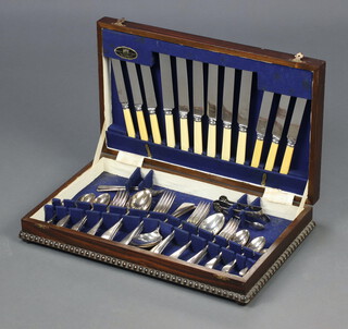 A canteen of Old English pattern chromium plated flatware contained in an oak canteen box 