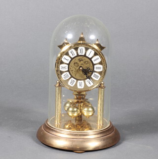 A brass anniversary clock under a glass dome 