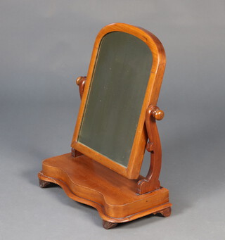 A Victorian arched plate dressing table mirror contained in a mahogany swing frame the base of serpentine outline 57cm h x 48cm w x 20cm d (sun bleached) 