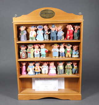 Twentyfour Danbury mint composition figures - Meet The Trotters, contained in a wood wall shelf 