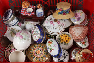 A collection of miniature trinket boxes contained in a red plastic crate