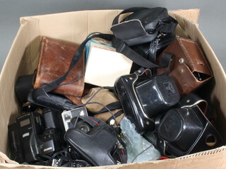 A collection of cameras including Ricoh zoom 35-135mm, Nikon, vintage Kodak etc, a collection of camera bags, lenses, accessories, minor cameras etc and a collection of video camcorders, Vanguard, Panasonic etc