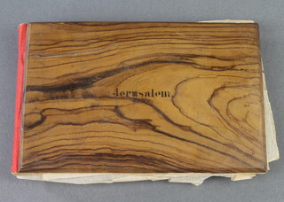 A 19th/20th Century album of coloured plates and dried flowers from the Holy Land, contained in an olive wood binding 
