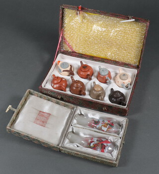 Eight miniature tan ware teapots in a plush case together with a pair of interior painted vases 10cm x 4cm cased
