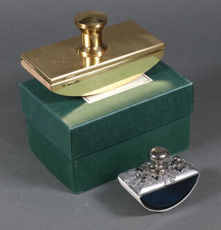 A polished brass desk blotter 8cm x 15cm x 8cm and a pewter and glass ditto 6cm x 8cm x 4cm 