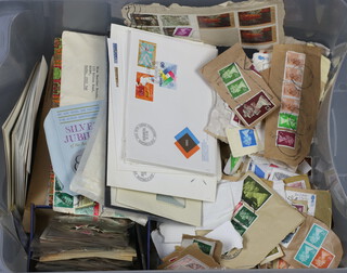 A collection of world stamps on paper and envelopes etc, contained in a  clear plastic crate 