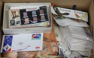A box of GB first day covers, used stamps on paper
