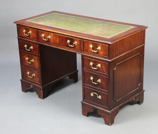 A Georgian style kneehole mahogany desk with inset tooled green leather writing surface, 1 long and 8 short drawers 78cm h x 122cm w x 49cm d (some contact marks) 