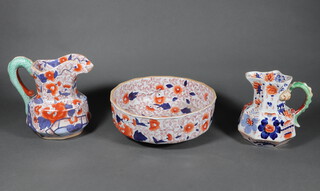 An Ironstone jug with serpent handle 26cm, ditto 19cm and a bowl 32cm 