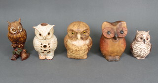 A collection of carved hardwood, ceramic and composition owls 