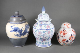 A modern Chinese blue and white jar and cover 40cm, a ditto decorated with dragon 36cm and an Imari ditto 25cm 