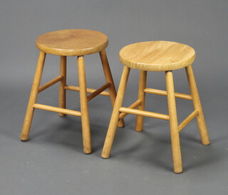 A pair of elm and beech circular stools raised on turned supports 45cm h x 31cm diam. 
