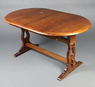 An oval dark elm refectory style dining table with concealed extra leaf raised on shaped supports with H framed stretcher 73cm h x 143cm l x 88cm w (water marks to the top) 