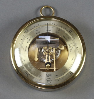 A Barigo aneroid barometer with gilt dial and contained in a gilt metal case 4cm h x 13cm diam. 

