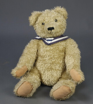 A large modern plush teddybear with pad feet and button eyes 56cm 