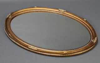 An oval bevelled plate wall mirror contained in a decorative gilt frame 102cm h x 75cm w 