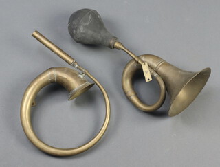 A brass car horn and 1 other 