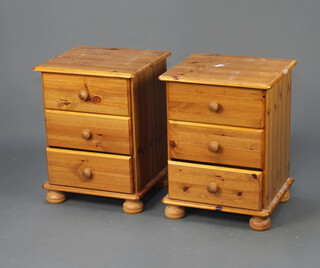 A pair of pine 3 drawer bedside chests with tore handles, on bun feet 58cm h x 44cm w x 35cm d (some contact marks)