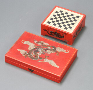 A rectangular Chinese Backgammon board decorated a dragon 6cm x 40cm x 8cm (clasp to lid a/f) together with a matching chessboard fitted a drawer 10cm x 34cm x 24cm 