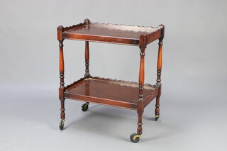 A Chippendale style rectangular mahogany 2 tier tea trolley on turned supports 72cm h x 61cm w x 41cm d 