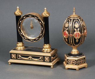 A Franklin Mint Faberge Mystery clock 22cm h x 17cm w x 8cm d together with a ditto egg 22cm x 7cm 