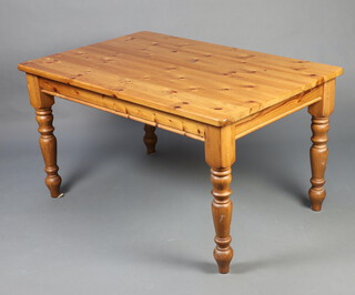 A rectangular pine kitchen table raised on turned supports 75cm h x 138cm l x 90cm w 