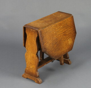 A 1930's Art Deco oak drop flap tea table with patented drop flap leg 51cm x 53cm x 17cm (some contact marks and ring marks)