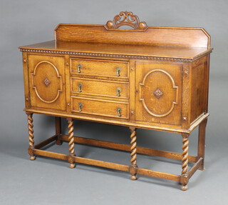 A 1930's carved light oak sideboard with raised back, fitted 3 drawers flanked by cupboards, raised on turned supports 130cm h x 151cm w x 55cm d 