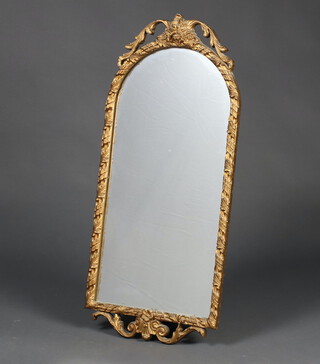 An arch plate mirror contained in a decorative gilt frame 74cm x 34cm 