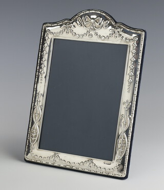 A modern repousse silver photograph frame with ribbons and bows 24cm x 17cm 