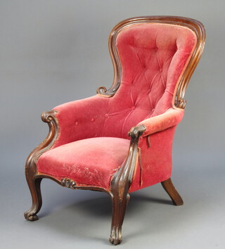 A Victorian mahogany show frame armchair upholstered in red buttoned velvet, raised on cabriole supports 101cm h x 65cm w x 59cm d (seat 30cm x 39cm) 
