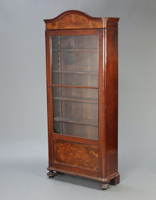 A 19th Century Continental arched mahogany display cabinet, fitted shelves enclosed by glazed panelled door, raised on bun feet 175cm h x 76cm w x 27cm d 