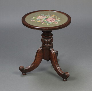 A circular occasional table with Berlin woolwork panel raised on turned column and tripod base, formerly a pole screen, 48cm h x 40cm diam. 
