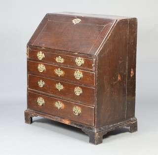 A Georgian oak and mahogany bureau, the fall front revealing a well fitted stepped interior above 4 drawers with brass plate drop handles, raised on bracket feet 102cm h x 91cm w x 50cm d  