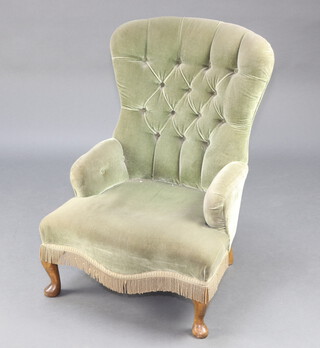 A 1950's Victorian style nursing chair upholstered in green buttoned material, raised on cabriole supports 84cm h x 62cm w x 49cm d (seat 32cm x 31cm)