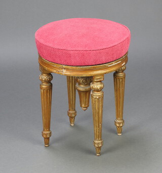 A 19th Century Louis style gilt painted revolving adjustable piano stool raised on turned and fluted supports 50cm h x 40cm 