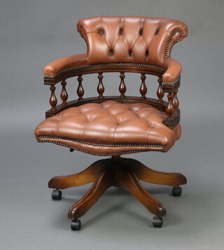 A Victorian style Captain's revolving office chair upholstered in brown buttoned leather, raised on a tripod base 80cm h x 63cm w x 51cm (seat 34cm x 37cm)  
