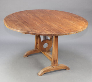 A Continental pine circular snap top table with lyre decoration 119cm diam. 