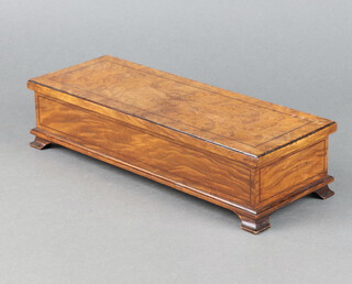 A 1930's rectangular figured walnut trinket box with hinged lid raised on ogee bracket feet 7.5cm h x 32cm w x 12cm d 