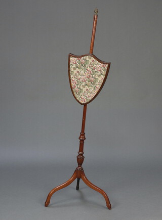 A 19th Century pole screen with shield shaped banner, raised on turned pillar and tripod base 125cm h x 40cm 