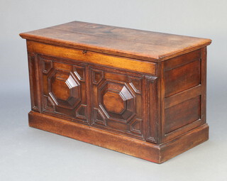 An 18th/19th Century oak panelled coffer with hinged lid and geometric mouldings, the interior fitted a candle box, raised on a later base 64cm h x 116cm w x 52cm d 