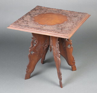 A square carved Eastern hardwood folding table raised on pierced supports 58cm h x 61cm w x 61cm d 