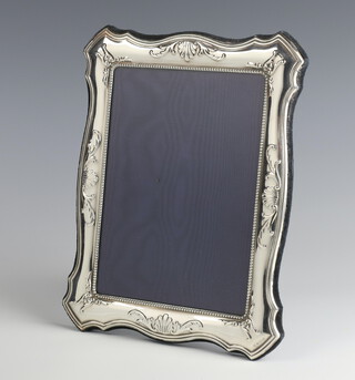 A modern repousse silver photograph frame 24cm x 19cm 