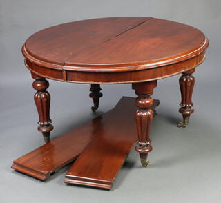 A Victorian mahogany oval extending dining table raised on turned and fluted supports with 2 extra leaves 72cm h x 119cm w x 120cm l x 175cm l when extended 