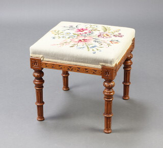 A Victorian square carved walnut show frame stool, the seat upholstered in Berlin woolwork, raised on turned and fluted supports 42cm h x 43cm 