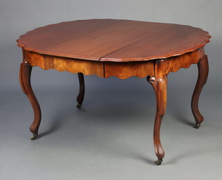 A Continental oval walnut extending dining table with wavy apron and pie crust edge, raised on cabriole supports 74cm h x  120cm w x 90cm l x 135cm l when extended  