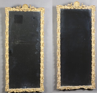 A pair of rectangular plate mirrors contained in decorative gilt frames 80cm x 36cm