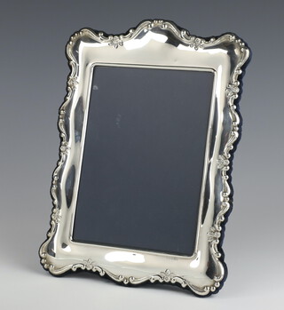 A modern repousse silver photograph frame 27cm x 19cm 